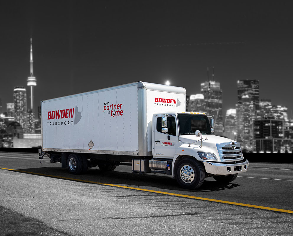 Bowden Transport straight truck on highway with city of Toronto in background