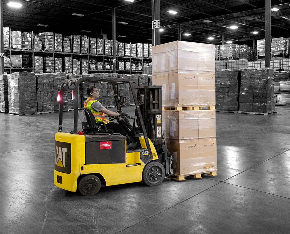 Bowden Transport warehouse with forklift operators moving pallets of freight